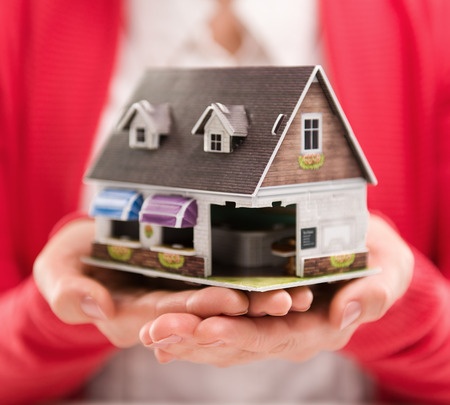 first-time-home-buyer-support Woman holding a small house