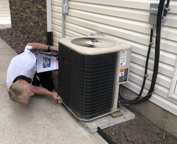 man-inspecting-stuff-outdoor inspection of air conditioner